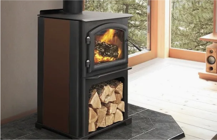 A wood stove is sitting in a living room next to a window.