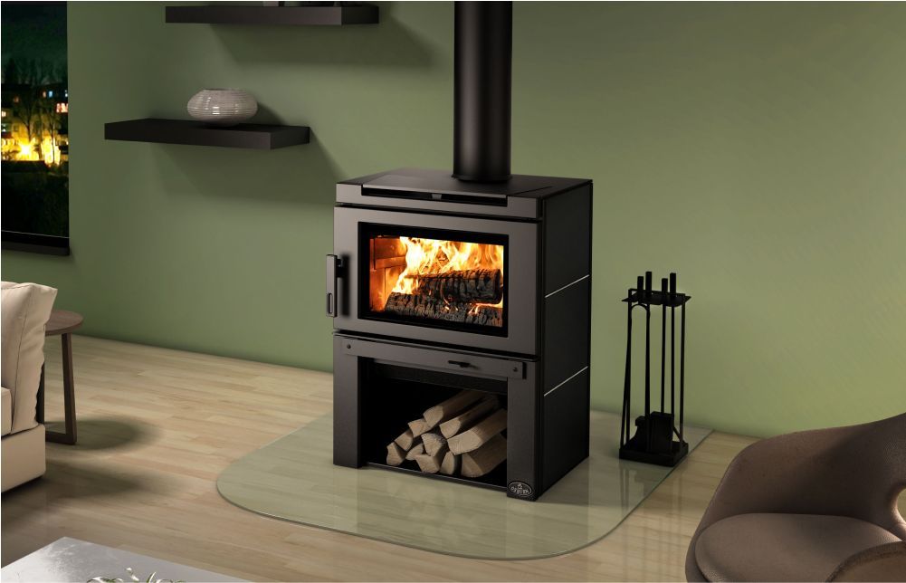A room with a wood stove and a picture on the wall