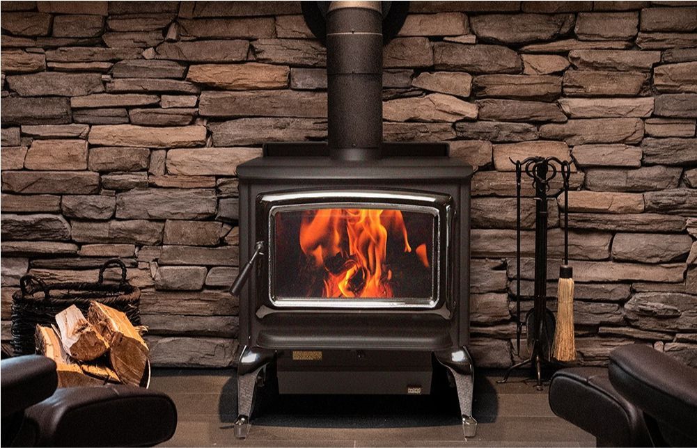 A room with a wood stove and a picture on the wall