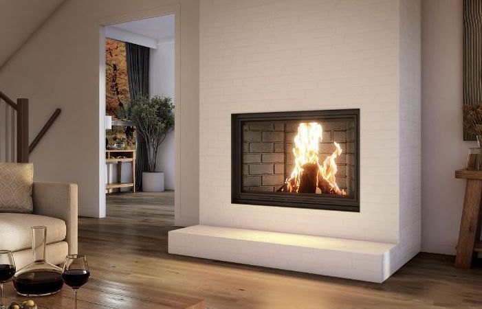 A living room with a fireplace and a coffee table.