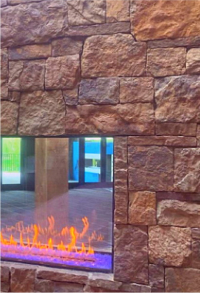 A fireplace is built into a stone wall