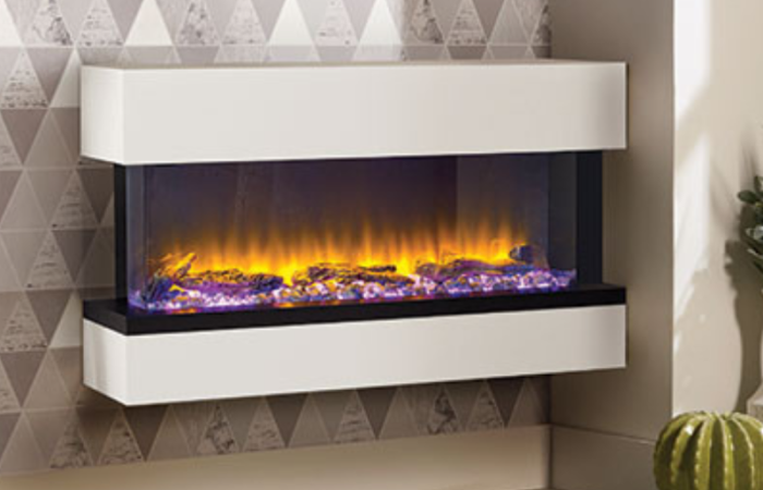 A white electric fireplace is hanging on a wall in a living room.