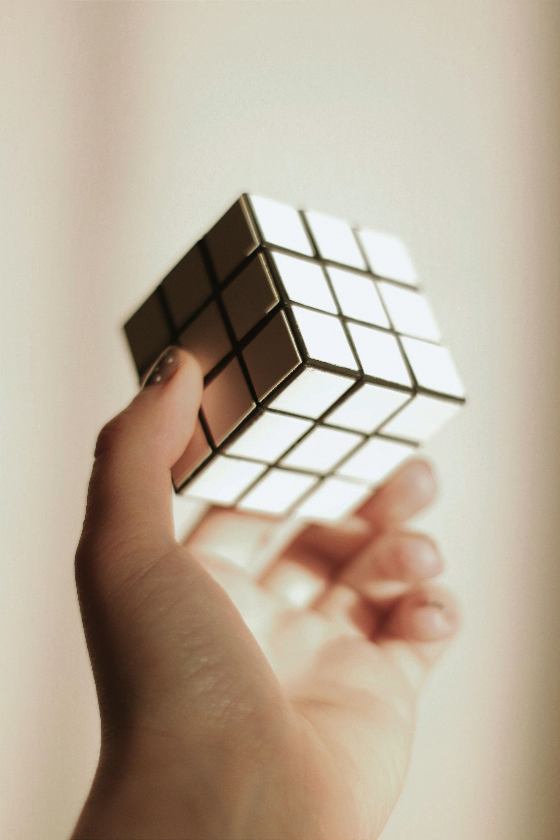 A person is holding a rubik 's cube in their hand