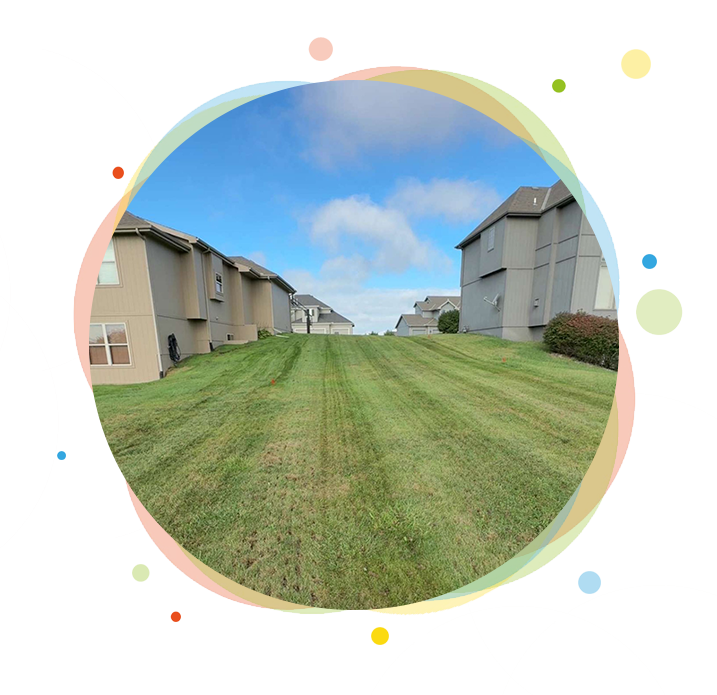 Landscaped rock waterfall with plants, lighthouse.