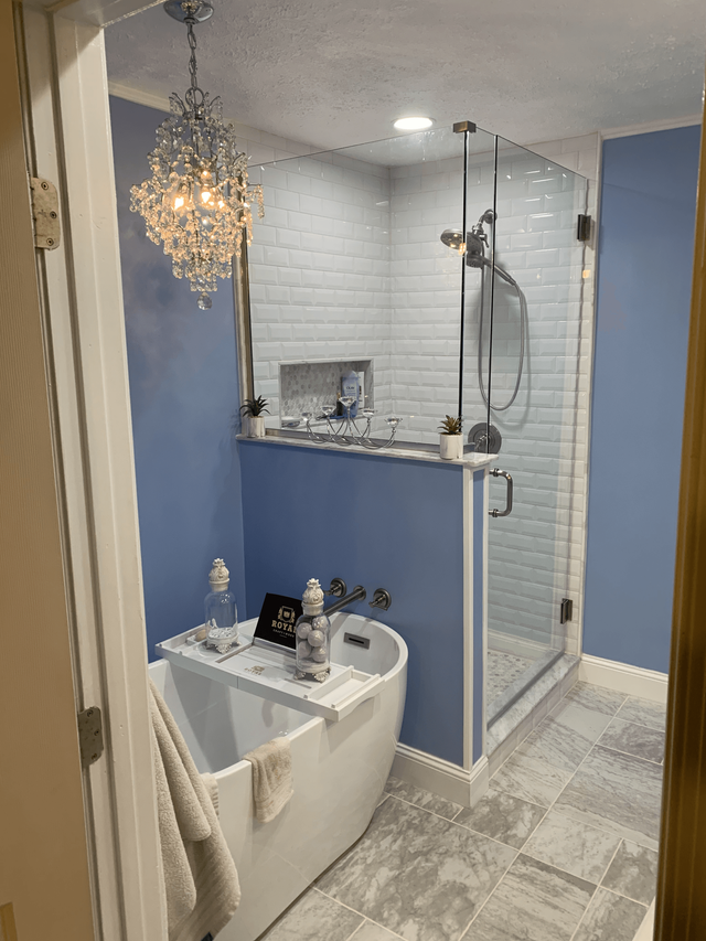 A bathroom with a bathtub and a walk in shower.