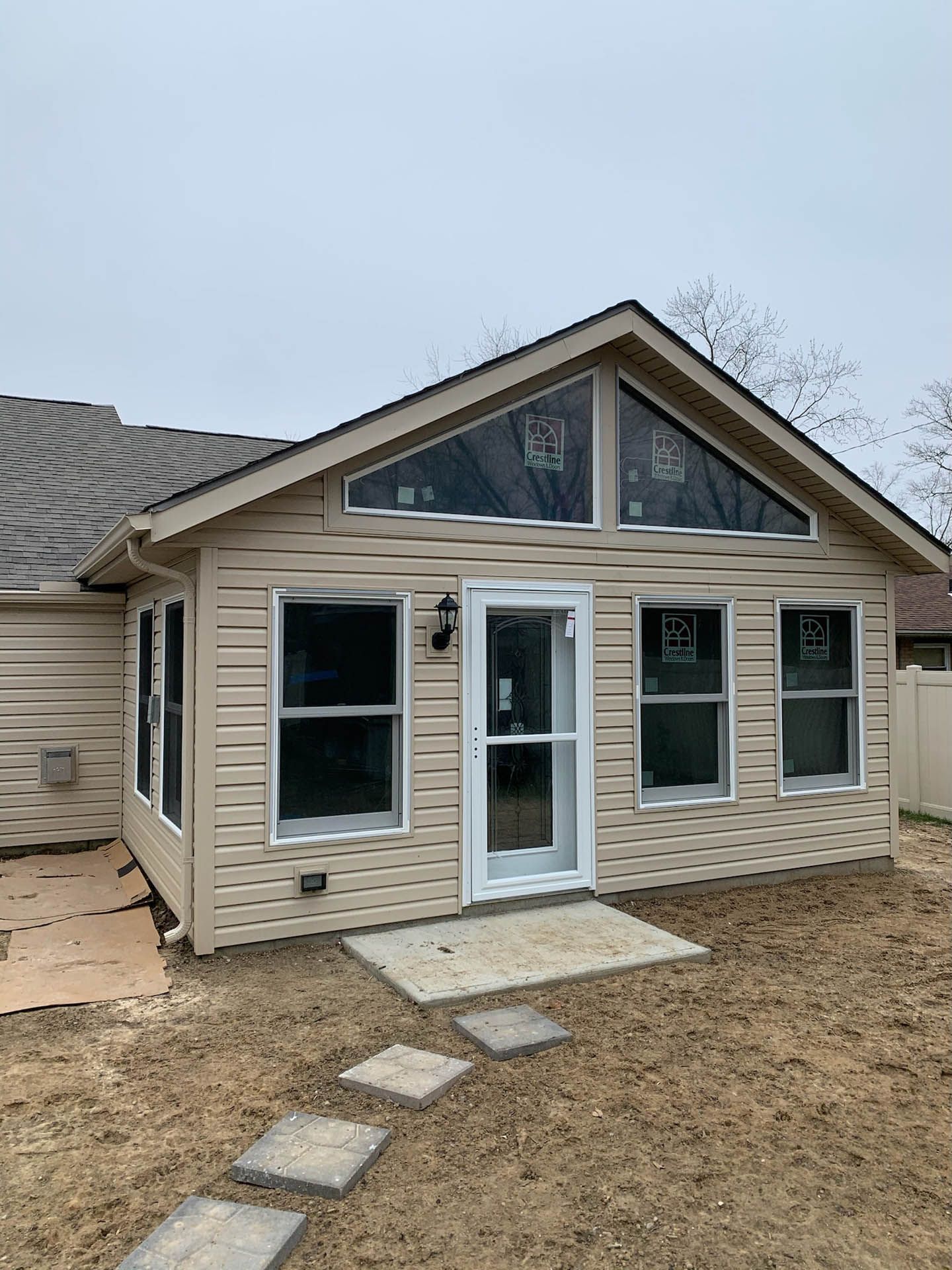 A house with a lot of windows and a walkway leading to it.