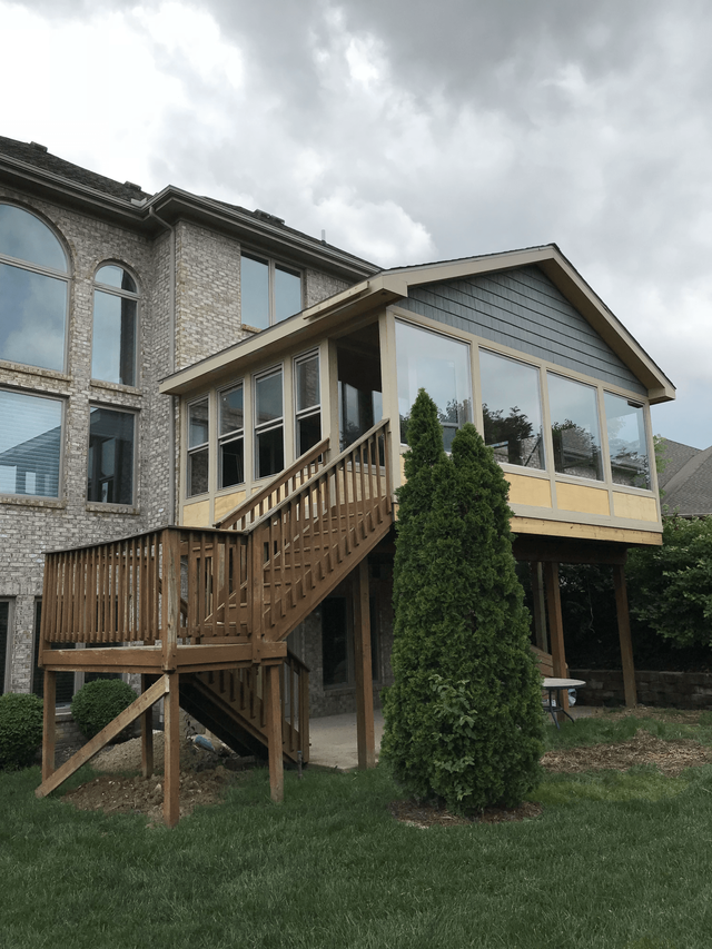 A large house with a large deck and stairs