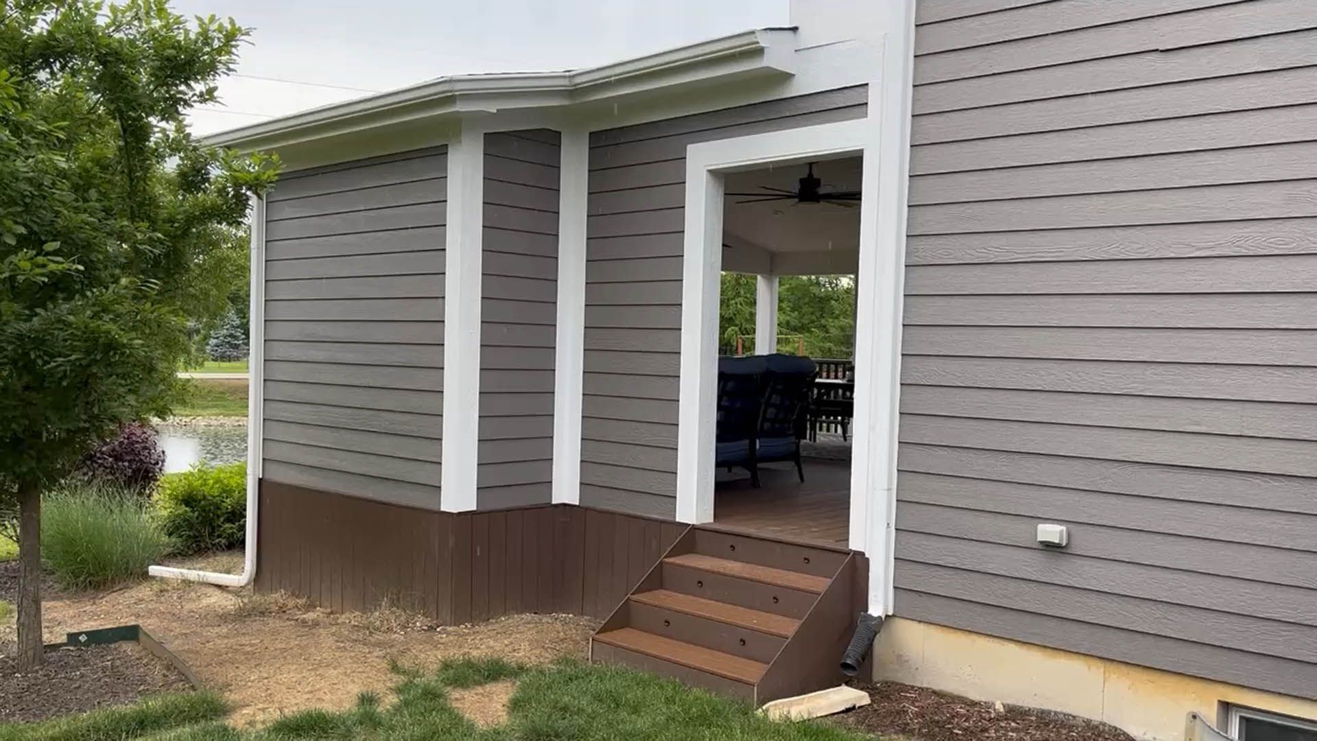 A house with a porch and stairs leading to it.