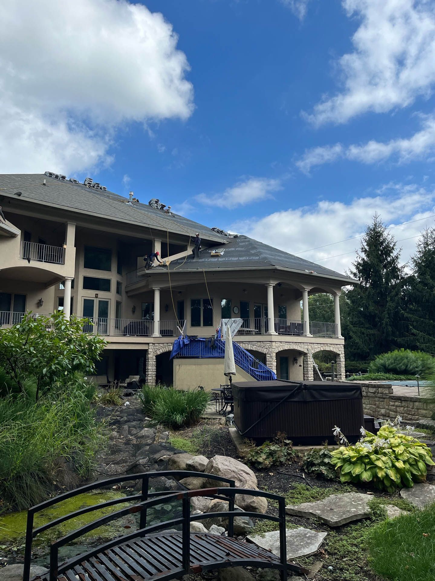 A large house with a bridge in front of it.