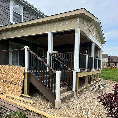 a house with a porch and stairs is being remodeled