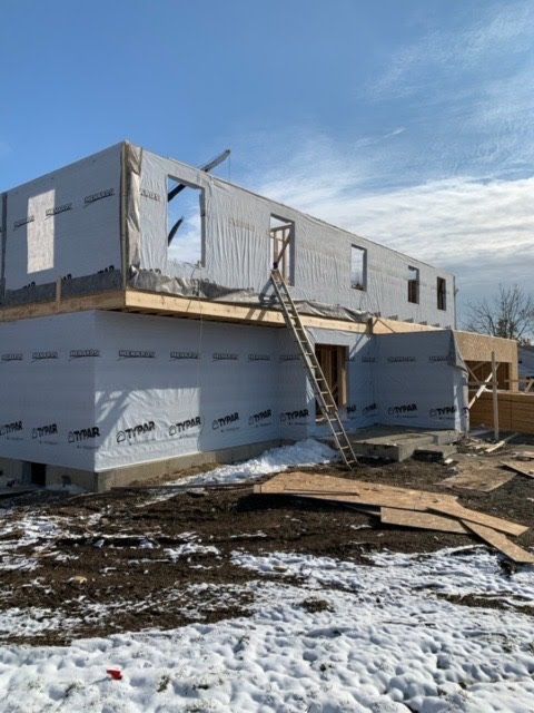 A house that is being built in the snow