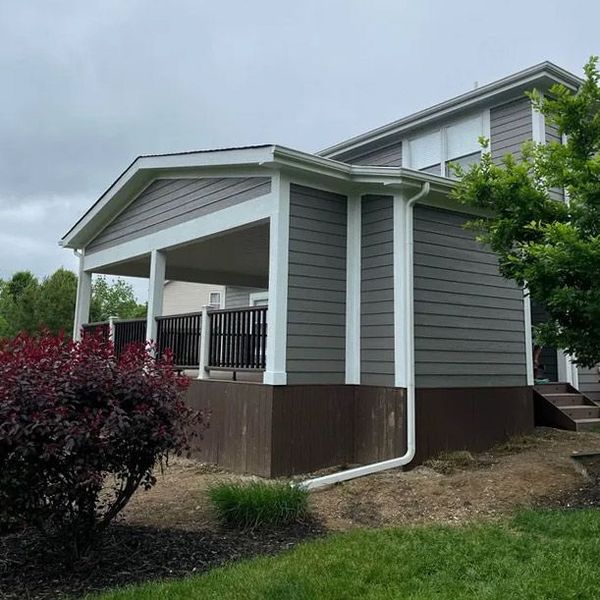 a home with a porch and stairs in the backyard - deck addition by Apollo General Contracting of Dayton