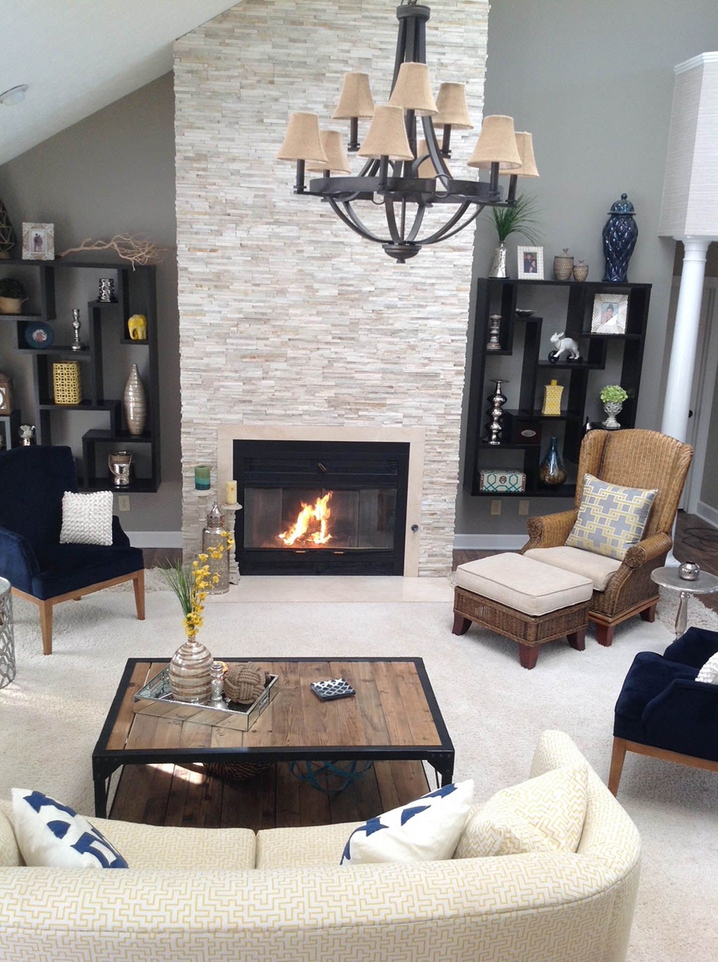 A living room with a fireplace and a chandelier