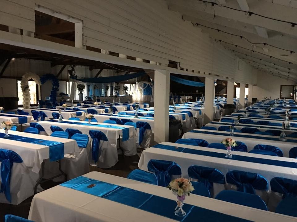 A large room filled with tables and chairs decorated in blue and white.