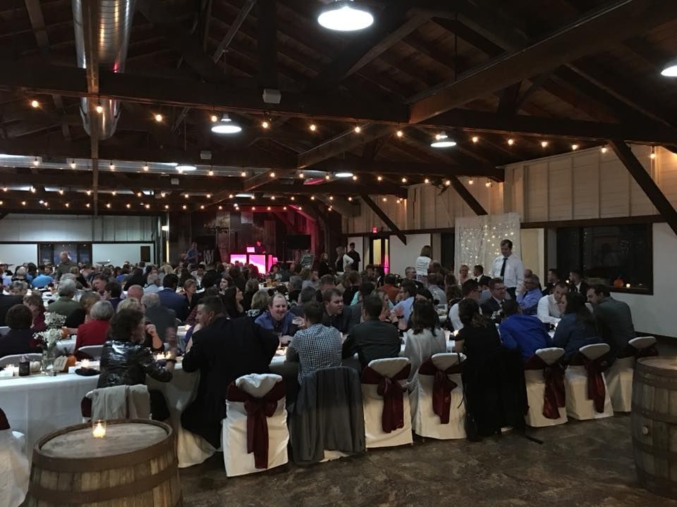 A large group of people are sitting at tables in a large room