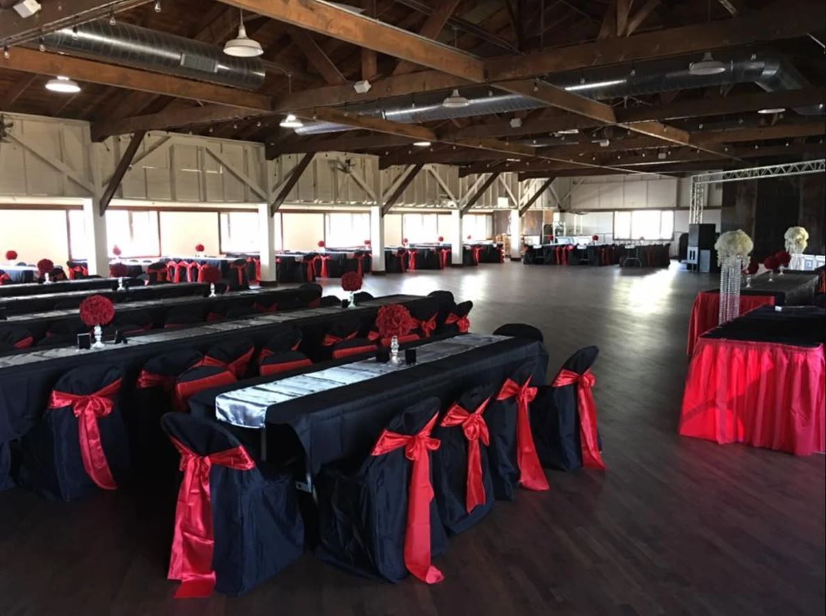 A large room with tables and chairs set up for a party