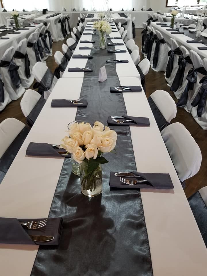 A long table with a vase of flowers on it.