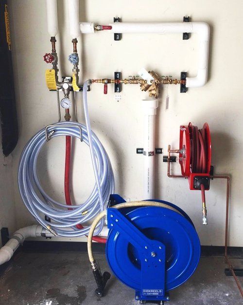A blue hose reel with a hose attached to it