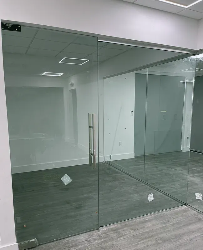 Custom Frameless Glass Office Partition Installation completed for a commercial interior project in Edgewater.