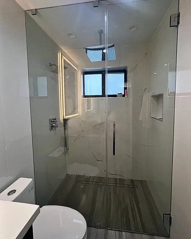 Custom Frameless Shower Enclosure fabricated and installed for a modern Midtown Miami condominium renovation.