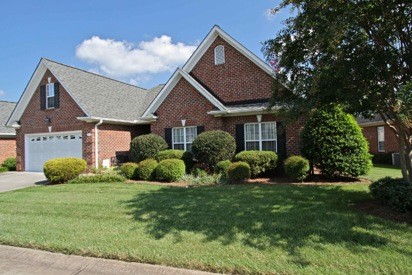 A large brick house with a white garage door