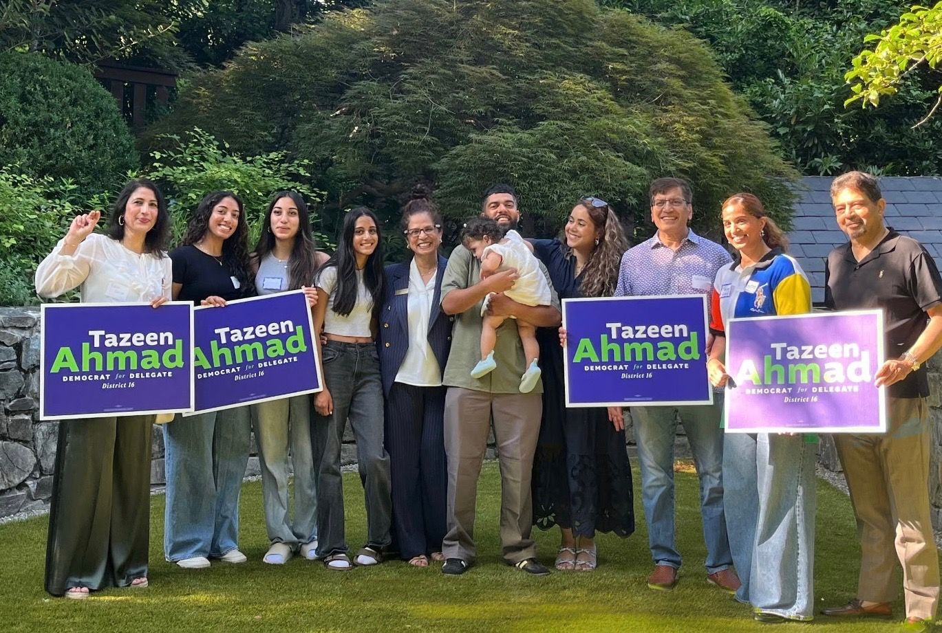 Tazeen Ahmad and family holding signs that say tazeen ahmad democrat delegate for district 16