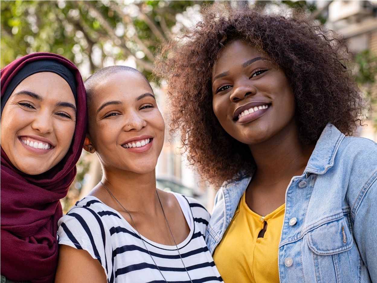 Three women from diverse backgrounds