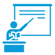 Teacher at a lectern pointing to a whiteboard with writing.