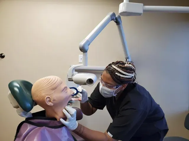 Dental Assistant working on dummy in class