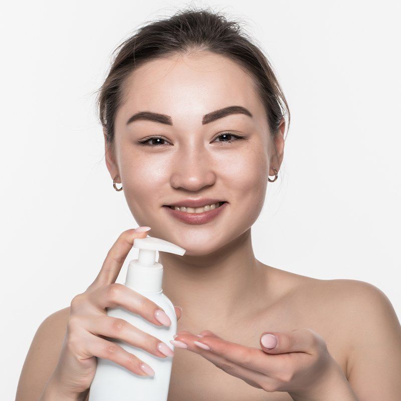 woman with lotion bottle