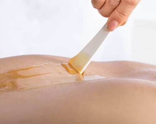 applying wax to back