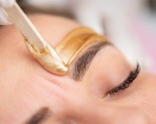 applying wax to eyebrows