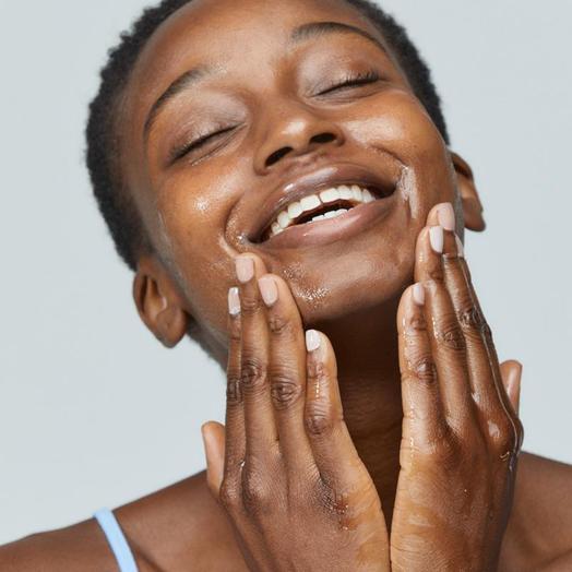 Woman applying Dermalogica pre cleanse