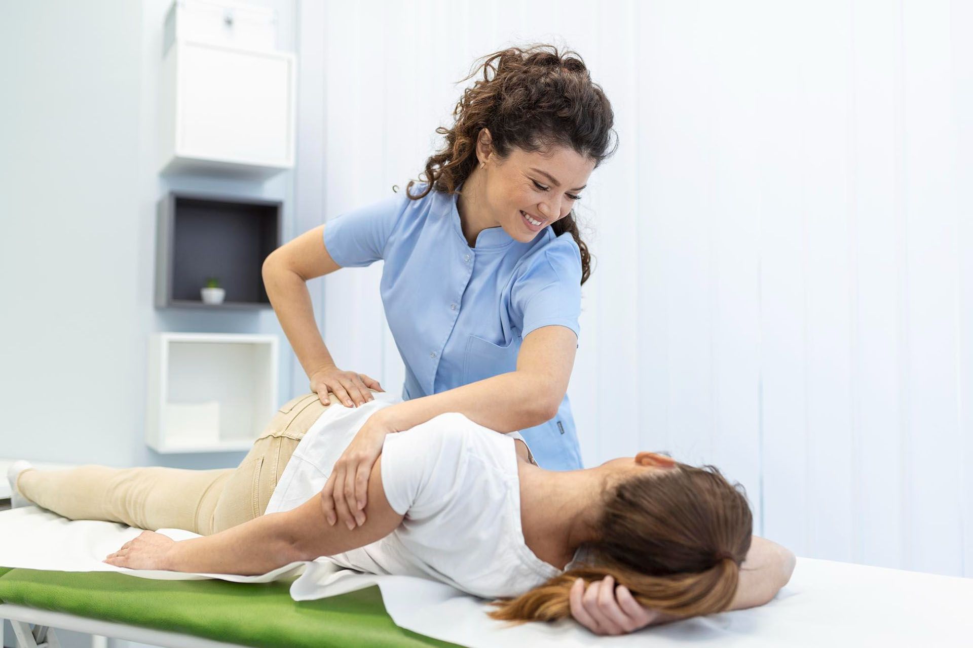 Woman receiving back massage from healthcare professional.