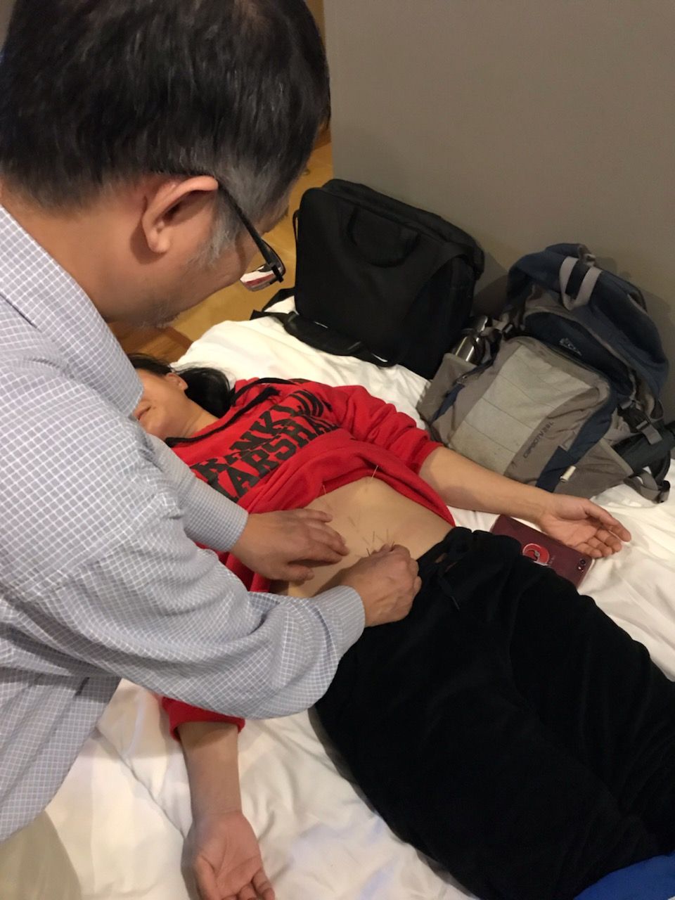 Dr. Yun Yu, MD Performing a Acupuncture Treatment