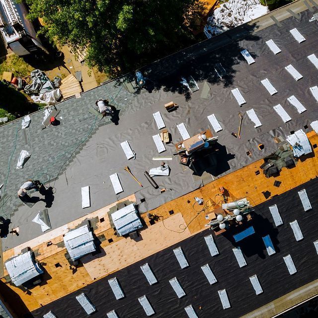 An aerial view of people working on a roof