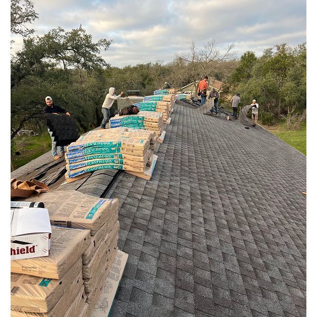 A group of people are working on a roof.