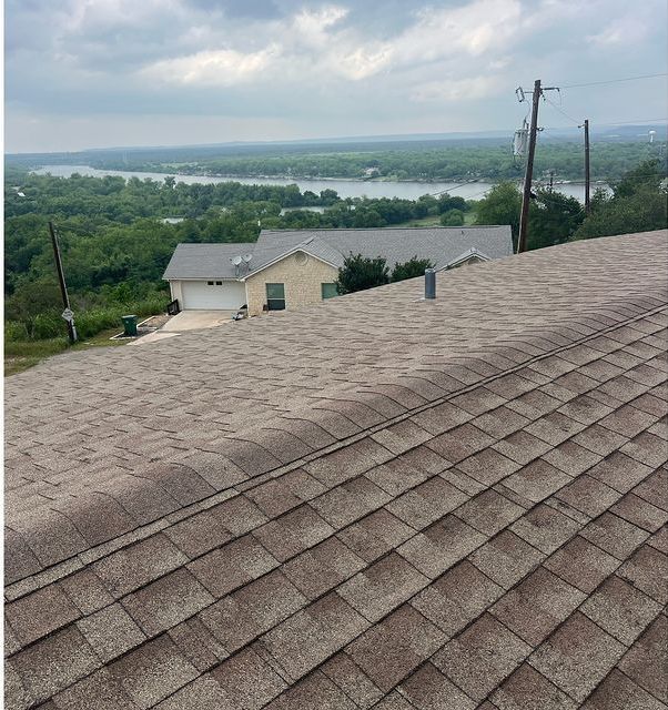 The roof of a house with a view of a lake