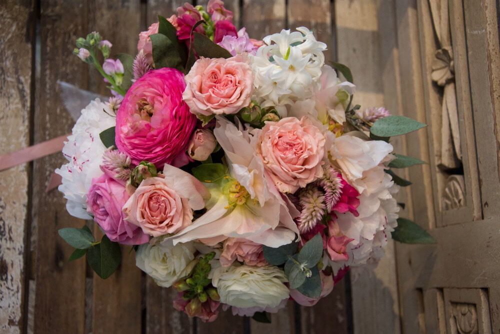 A Bouquet of Pink and White Flowers is Sitting on a Wooden Table — The Flower Station Townsville In Kirwan, QLD