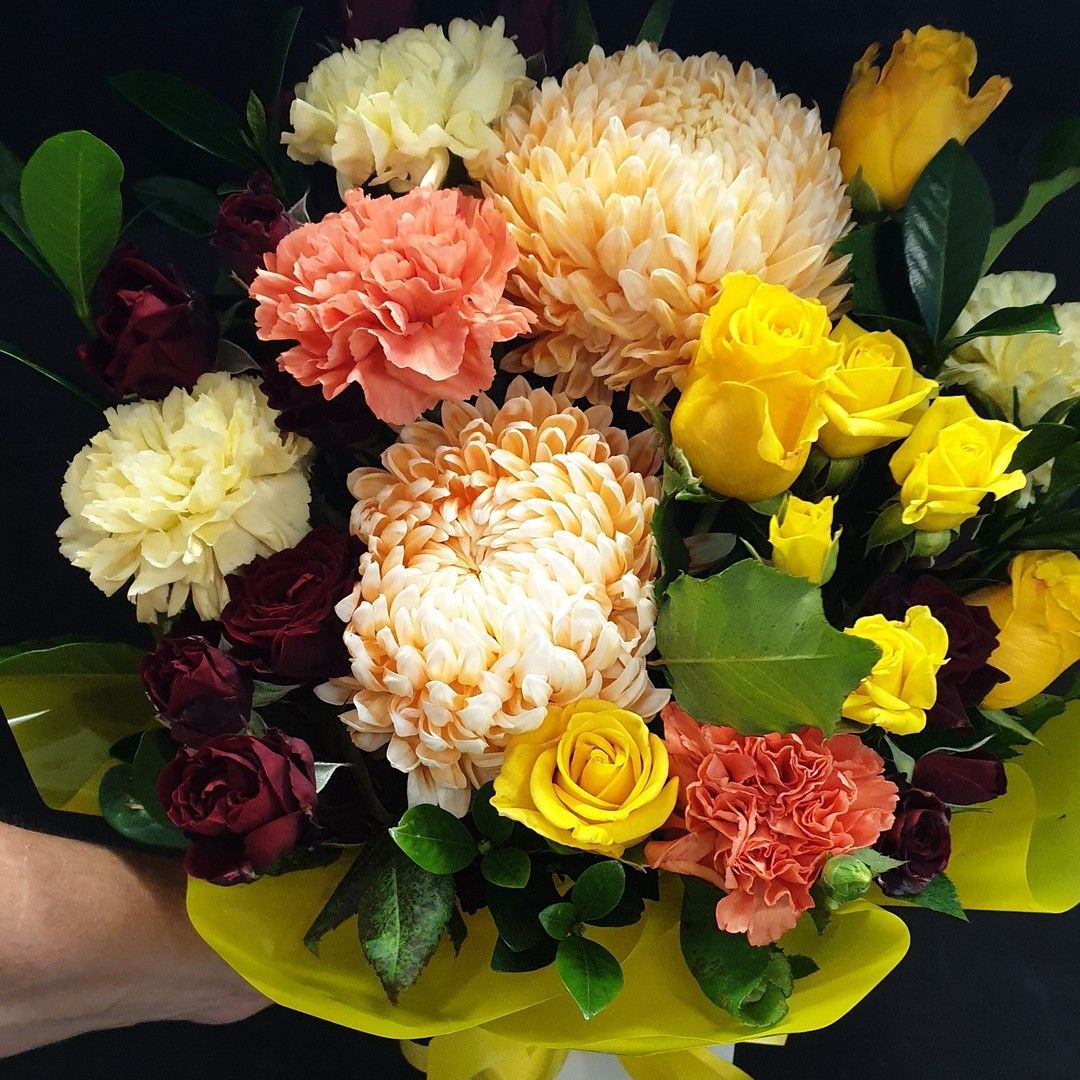 A Basket Filled With Yellow Daisies and Red Carnations — The Flower Station Townsville In Kirwan, QLD A Basket Filled With Yellow Daisies and Red Carnations — The Flower Station Townsville In Kirwan, QLD