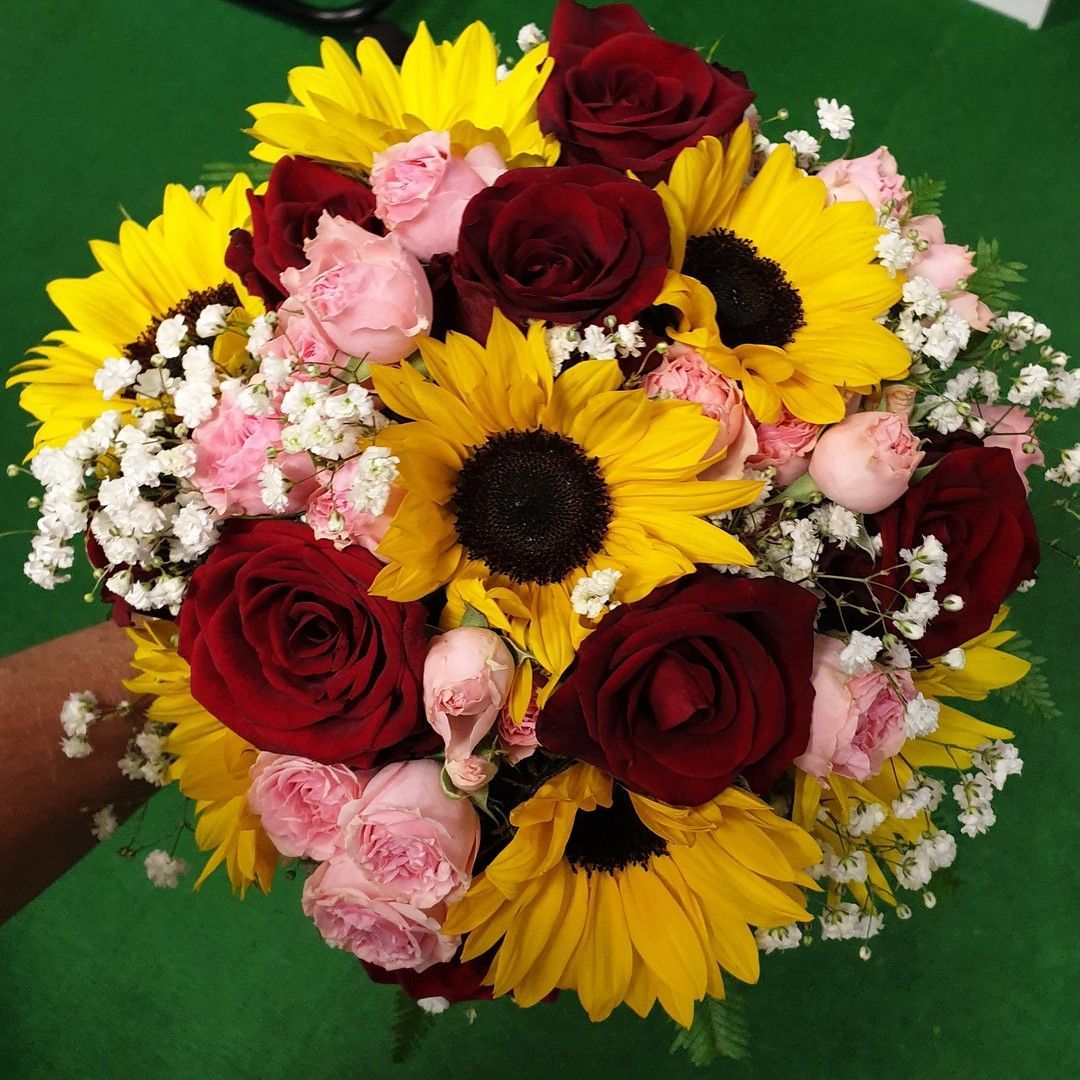 A Woman is Holding a Bouquet of Flowers in Her Hands — The Flower Station Townsville In Kirwan, QLD