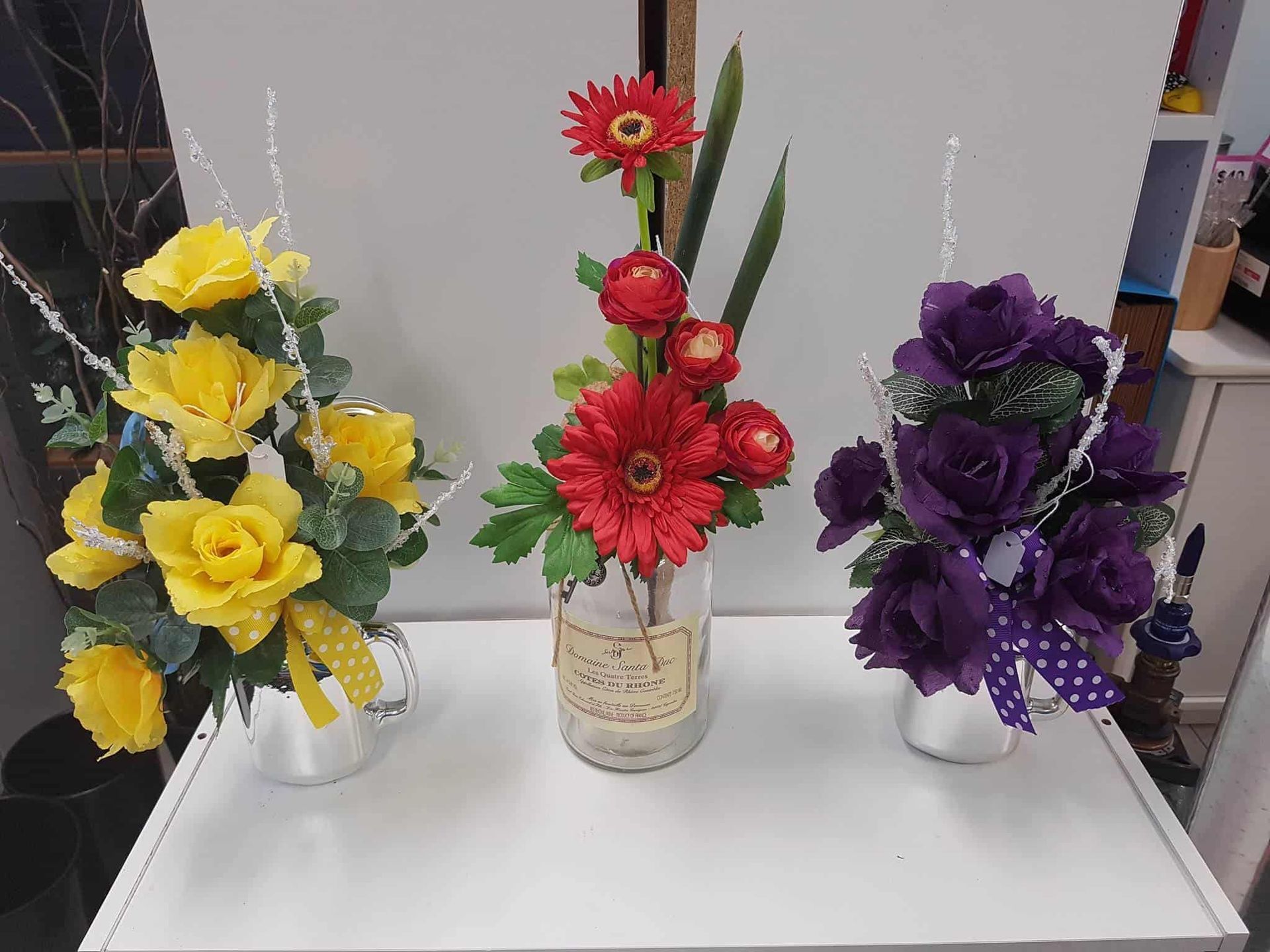 Three Vases Filled With Flowers Are Sitting on a Table — The Flower Station Townsville In Kirwan, QLD