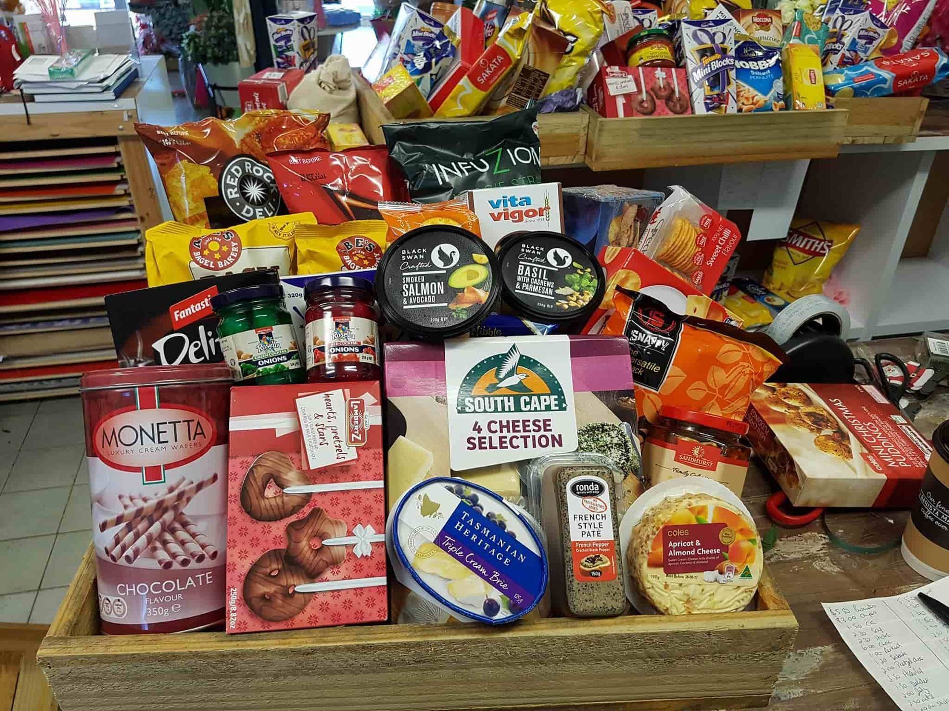 A Wooden Box Filled With a Variety of Snacks is Sitting on a Table — The Flower Station Townsville In Kirwan, QLD