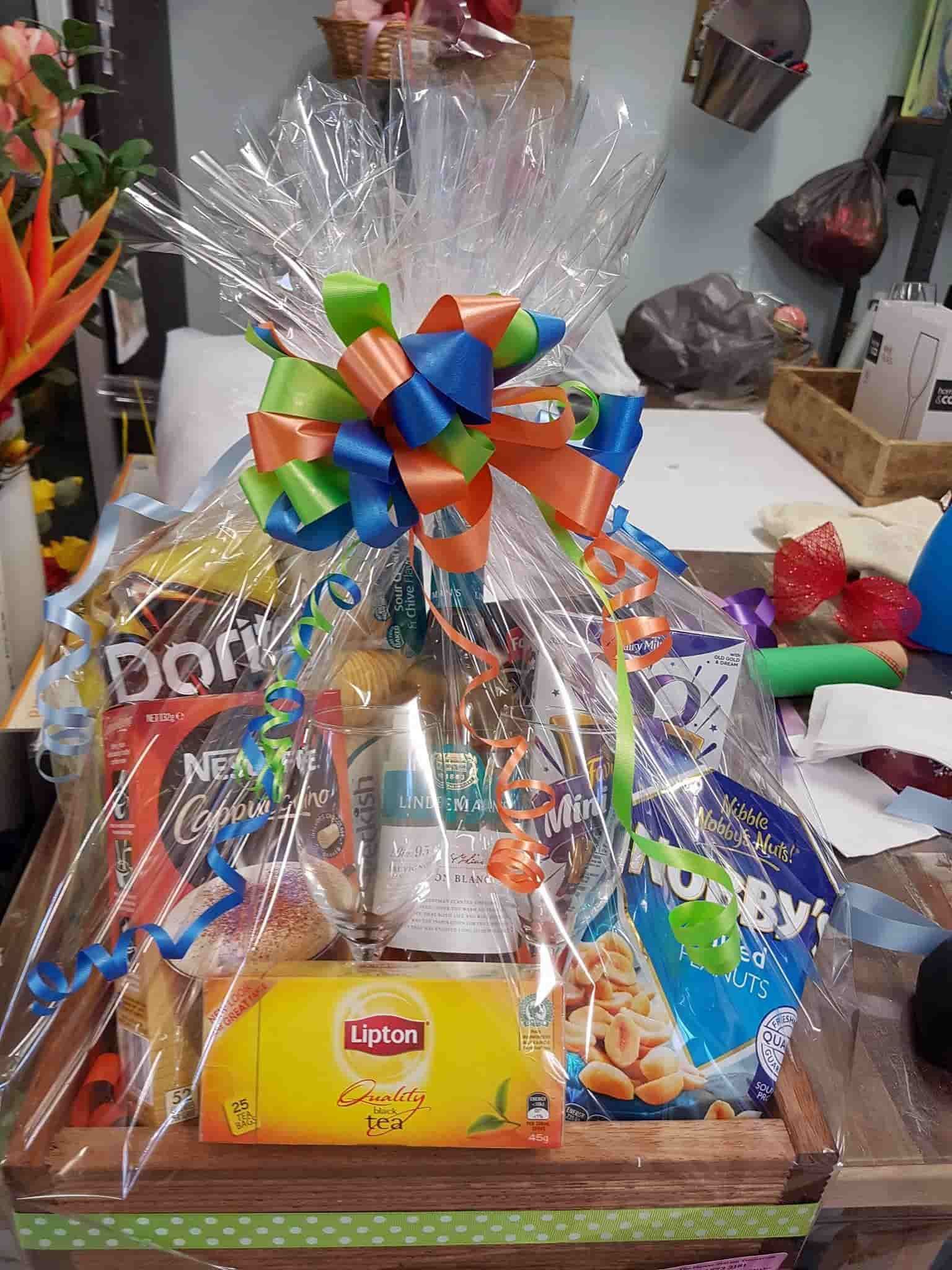 A Wooden Tray Filled With a Variety of Snacks and a Gift Card — The Flower Station Townsville In Kirwan, QLD A Wooden Tray Filled With a Variety of Snacks and a Gift Card — The Flower Station Townsville In Kirwan, QLD