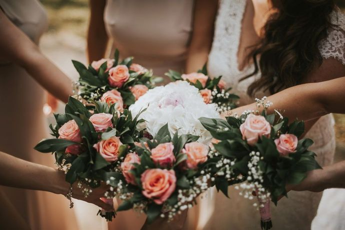 A Bride and Her Bridesmaids Are Holding a Bouquet of Flowers in Their Hands — The Flower Station Townsville In Kirwan, QLD A Bride and Her Bridesmaids Are Holding a Bouquet of Flowers in Their Hands — The Flower Station Townsville In Kirwan, QLD