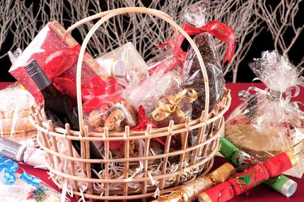 A Wicker Basket Filled With Gifts and Crackers on a Table — The Flower Station Townsville In Kirwan, QLD