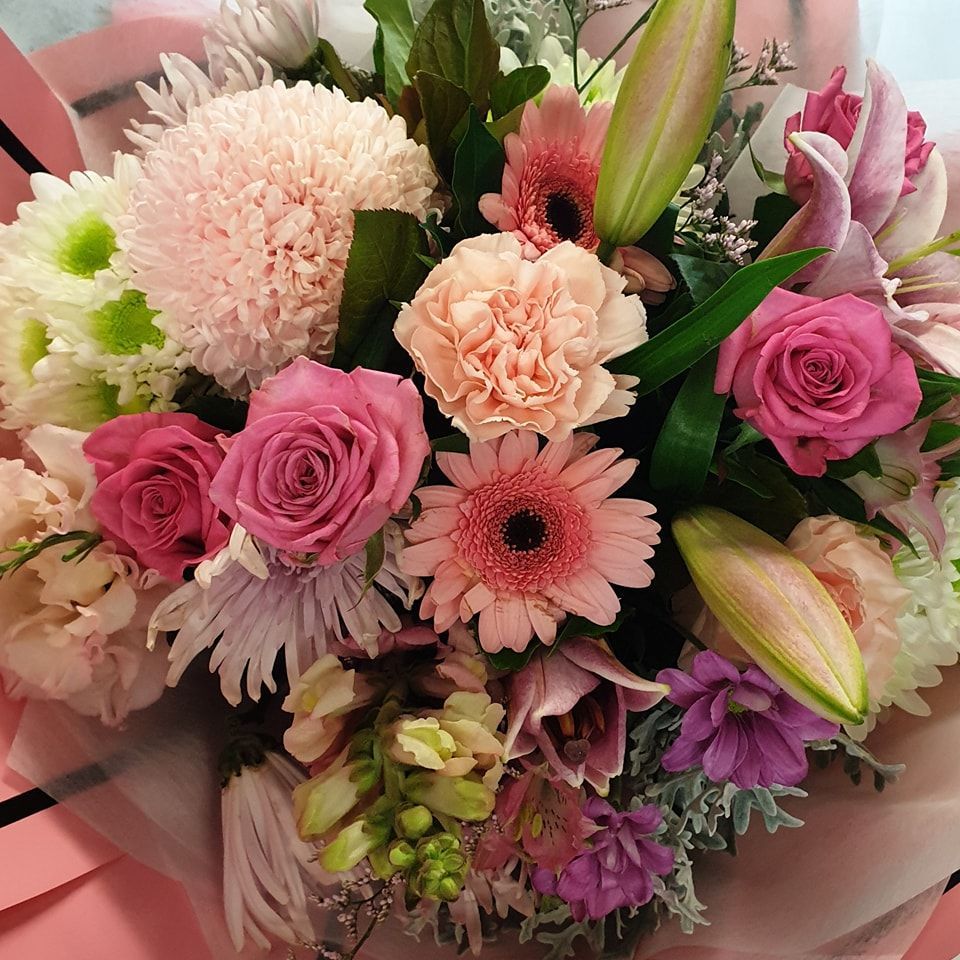 A Bouquet of Pink and Yellow Flowers on a Table — The Flower Station Townsville In Kirwan, QLD