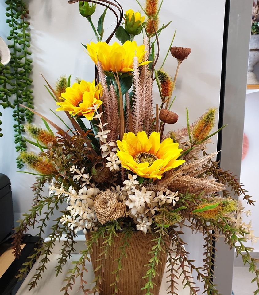 A Podium Decorated With White Flowers and Candles on a Wooden Floor — The Flower Station Townsville In Kirwan, QLD A Podium Decorated With White Flowers and Candles on a Wooden Floor — The Flower Station Townsville In Kirwan, QLD