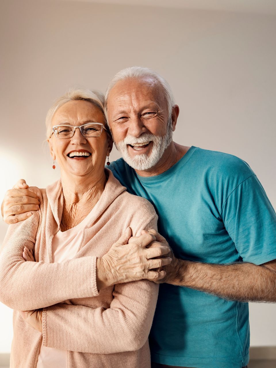 Happy older couple smiling with their dentures