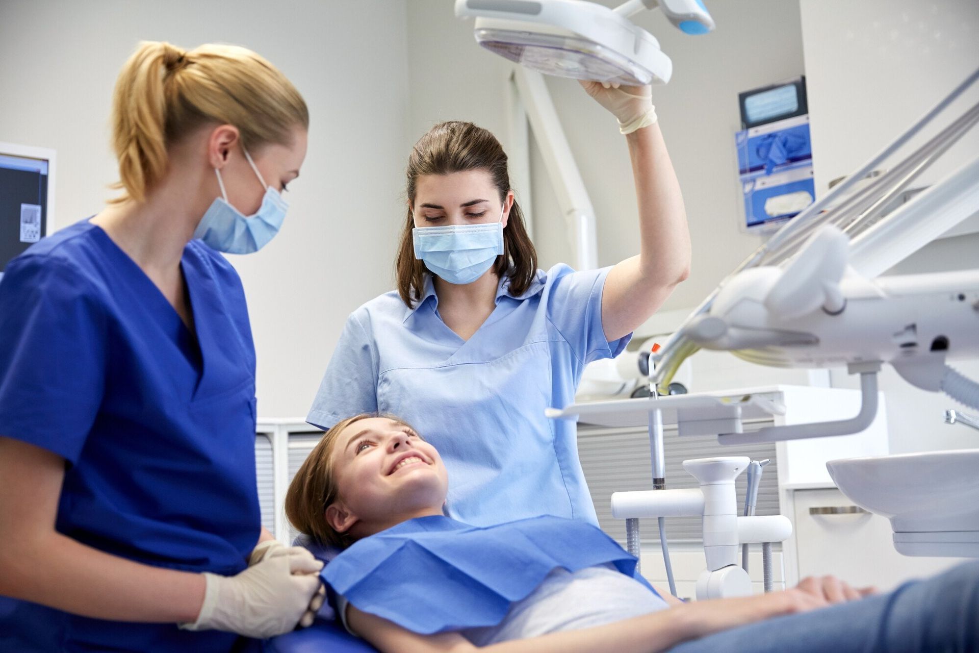 two dentists working with patient